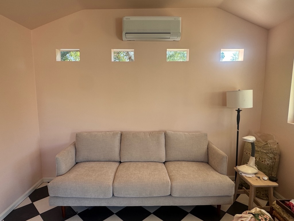 Samsung mini split wall unit installed in pink she shed interior — Arizona